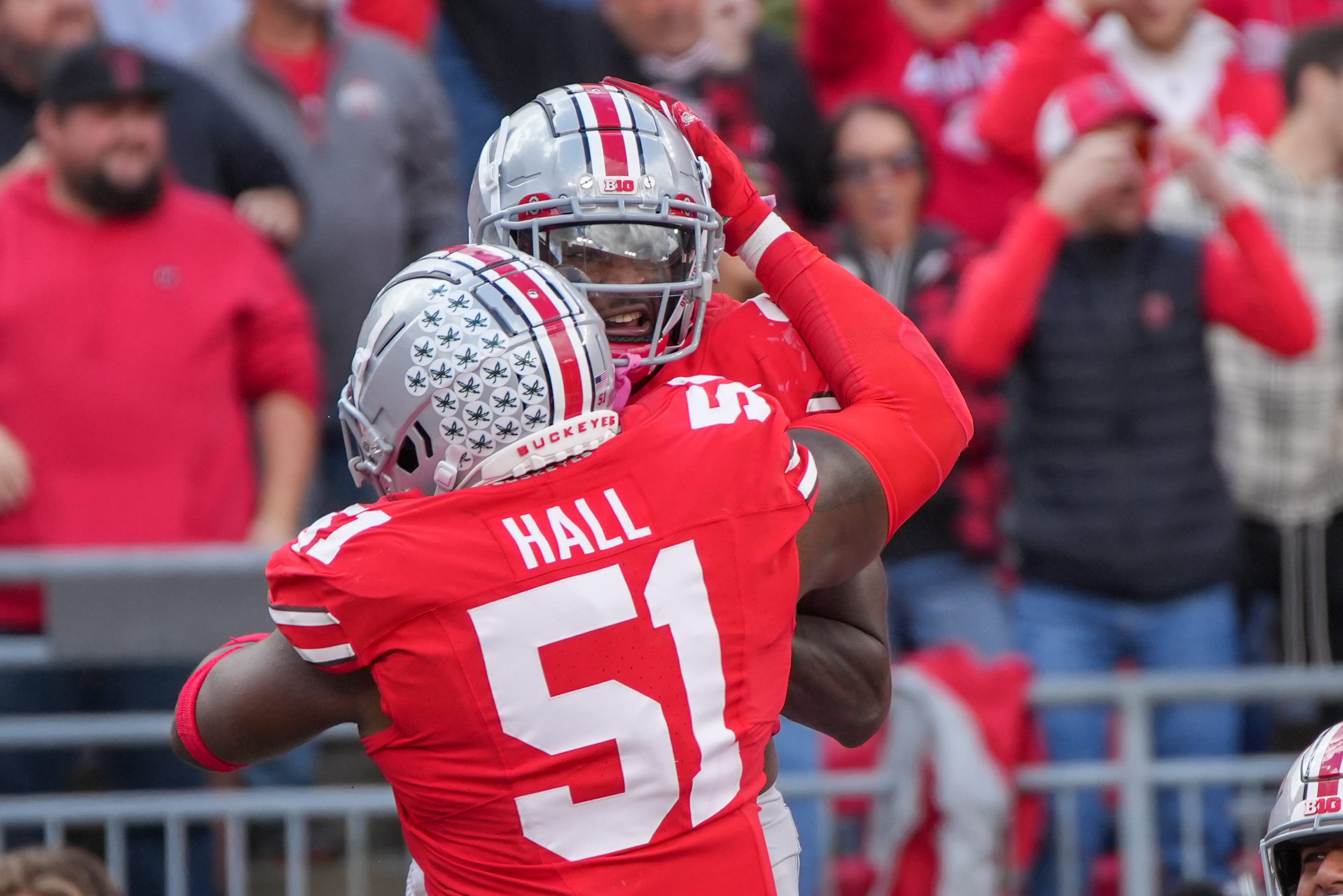 Oct 7, 2023; Ohio Stadium, Ohio, USA;
Ohio State Buckeyes safety Josh Proctor (41) celebrates with defensive tackle Michael Hall Jr. (51) after intercepting the ball and scoring a touchdown during their game against the Maryland Terrapins on Saturday, Oct. 7, 2023.