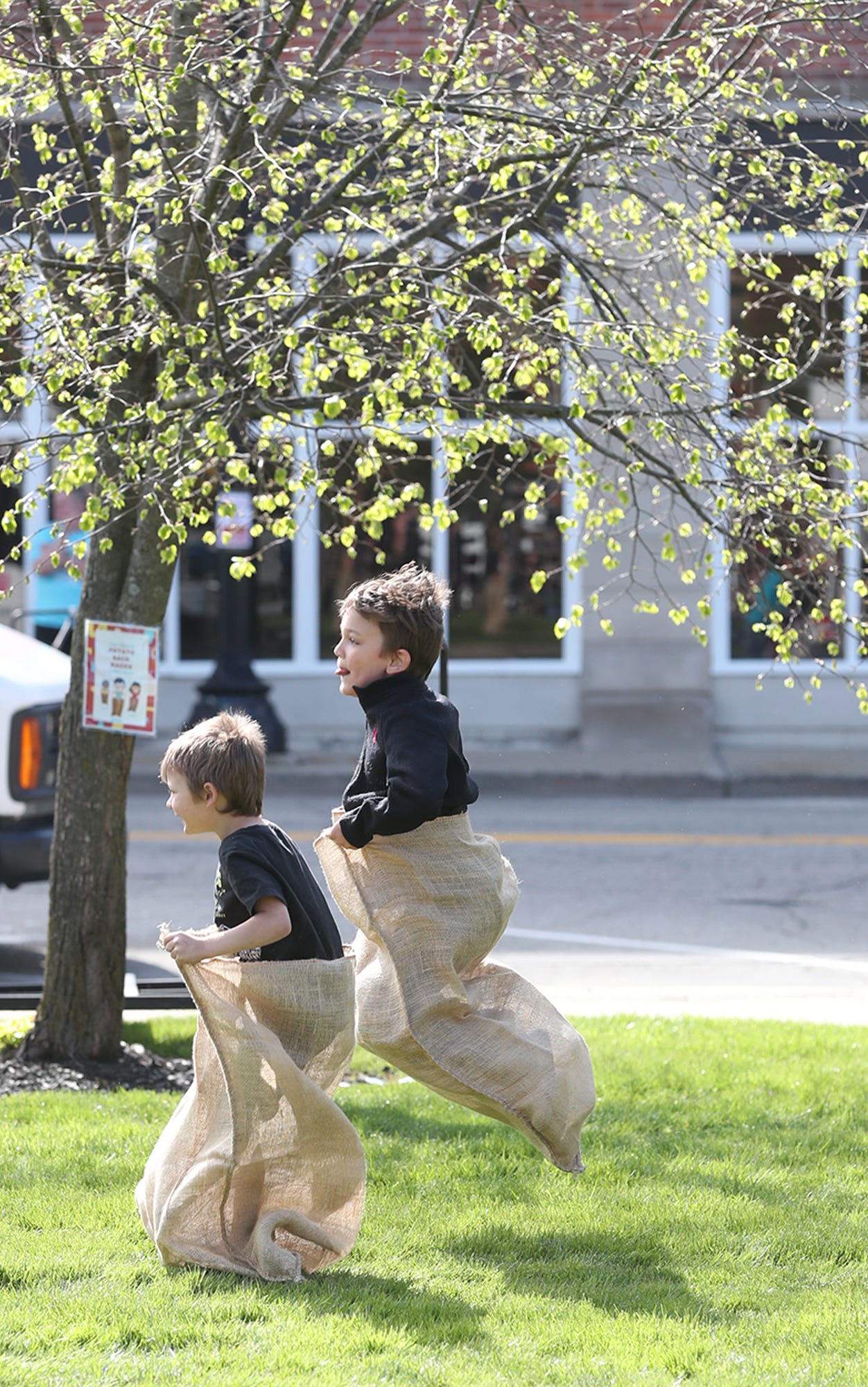 Jackson Lloyd, 4 and his brother Quentin, 6 take part in a potato sack race at the Ravenna JoJo Fest on Friday, April 26, 2024 in Ravenna.