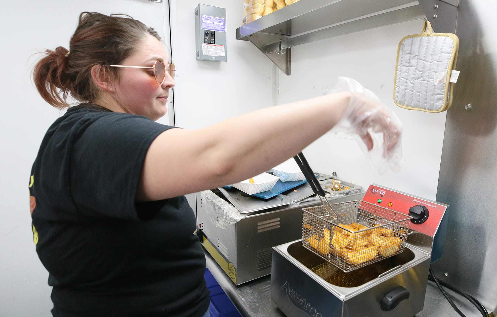 Becca Lydick of The Wiener Guy, serves up samples of their Jo-Jos during the Ravenna JoJo Fest on Friday, April 26, 2024 in Ravenna.